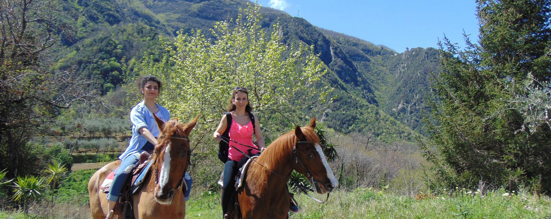Two girls riding a horse in the Vesuvius National Park