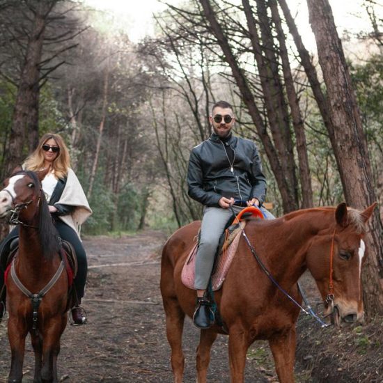 Couple riding a horse in the Vesuvius National Park