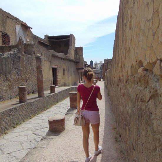 Girl walking in the street of ancient Ercolano