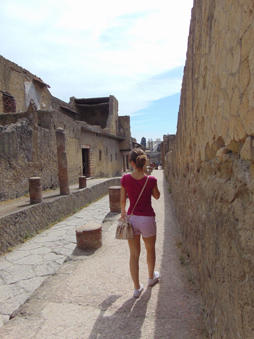 Girl walking in the street of ancient Ercolano
